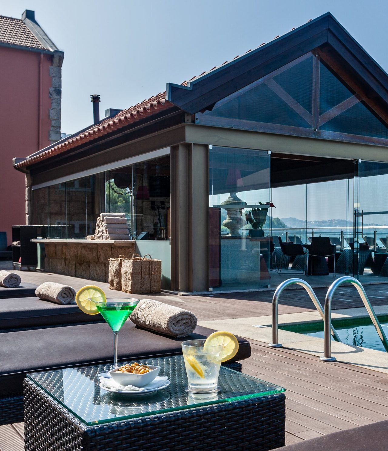 Restaurante do Pestana Palácio do Freixo, Hotel 5 Estrelas no Porto, Monumento Nacional, com área exterior elegante junto à piscina, onde bebidas e snacks são servidos em mesas de vidro sob luz natural