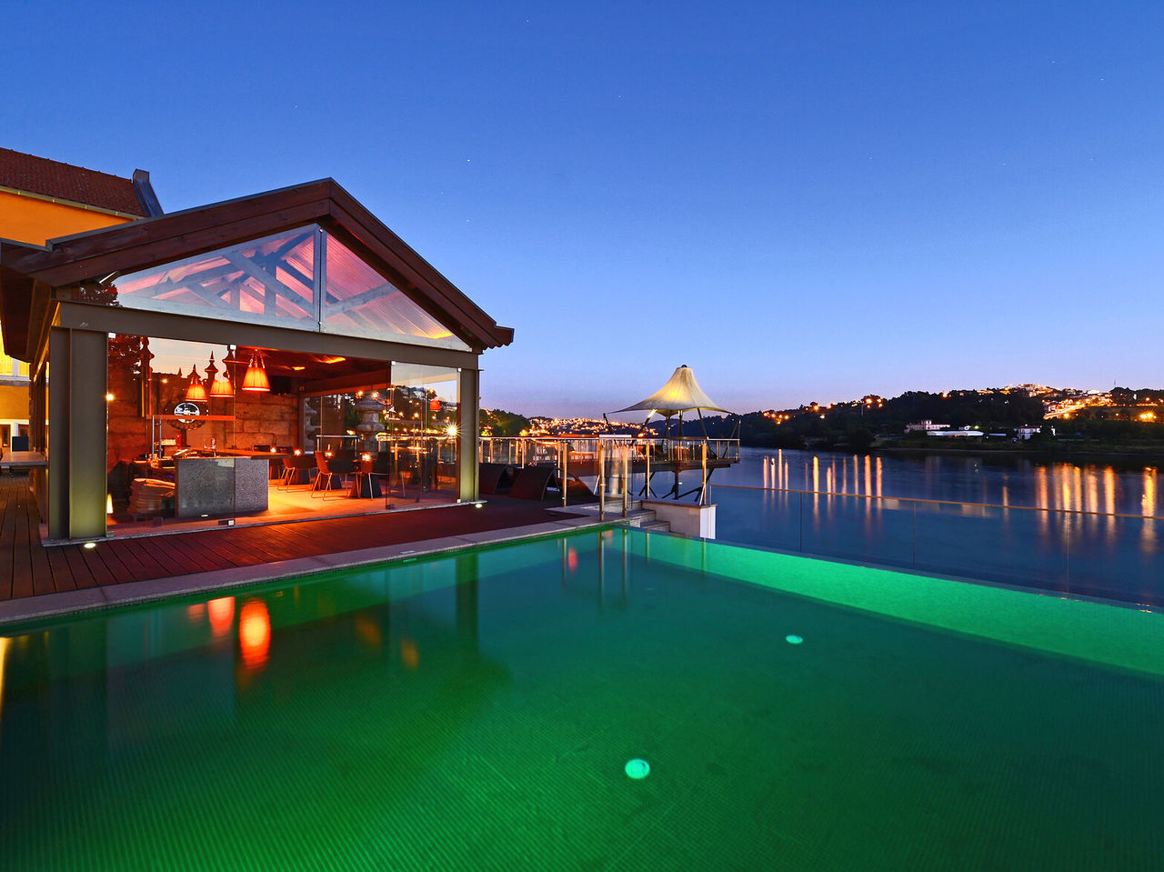 Restaurante do Pestana Palácio do Freixo, Hotel 5 Estrelas no Porto, Monumento Nacional, com esplanada iluminada junto à piscina e vista noturna sobre o rio Douro