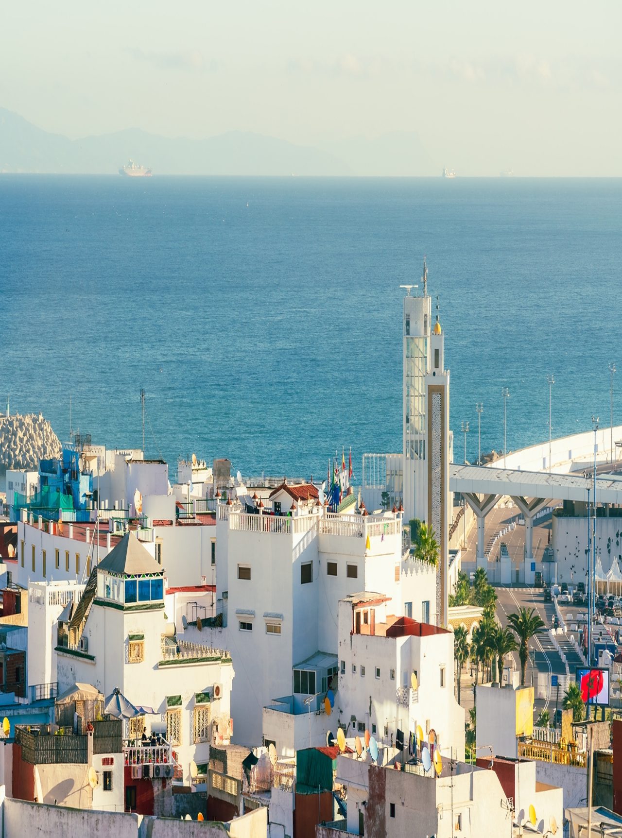 View of the city of Tangier, Morocco, with white buildings of traditional Moroccan architecture and the sea in the background