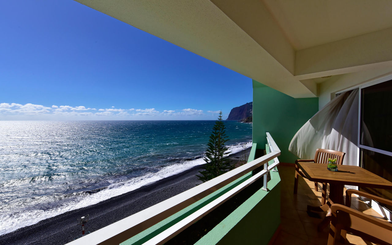 Balcony with a table and sea view at Pestana Ocean Bay All Inclusive, a 5-star hotel in Funchal, Madeira