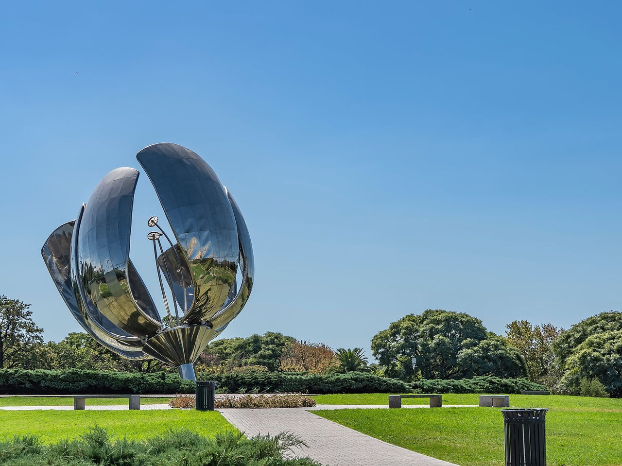 Explore Hotels in Buenos Aires featuring a reflective steel flower sculpture rising above a green city park